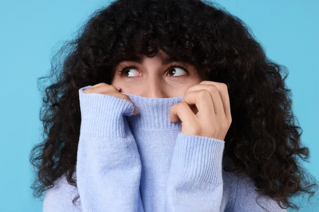 Verlegen? Een nepglimlach helpt al.